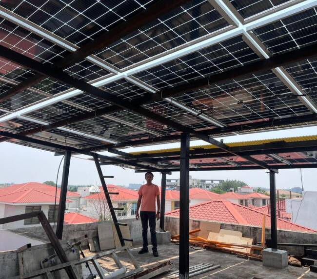 image of Satisfied solar user reducing electricity bills with PM Surya Ghar Yojana subsidy.